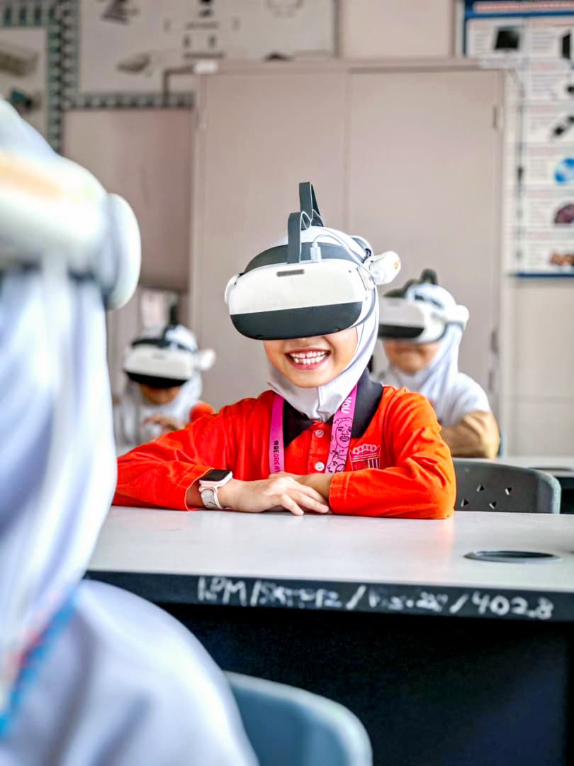 A student laughing while exploring a VR headset