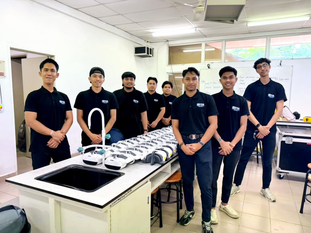 The GHA team standing beside the row of VR headsets