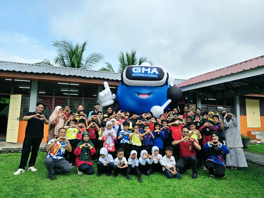Students making heart signs with the GHA mascot at their school